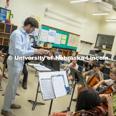 Dameer Gustafson, junior music education major, teaches the second-year string class in preparation for their concert. UNL/LPS String Project. April 10, 2024. Photo by Kristen Labadie / University Communication.